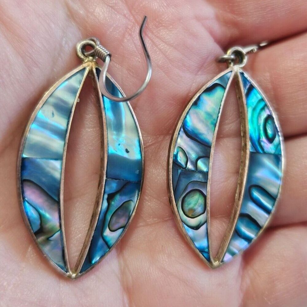 Alpaca earrings are silver with blue abalone